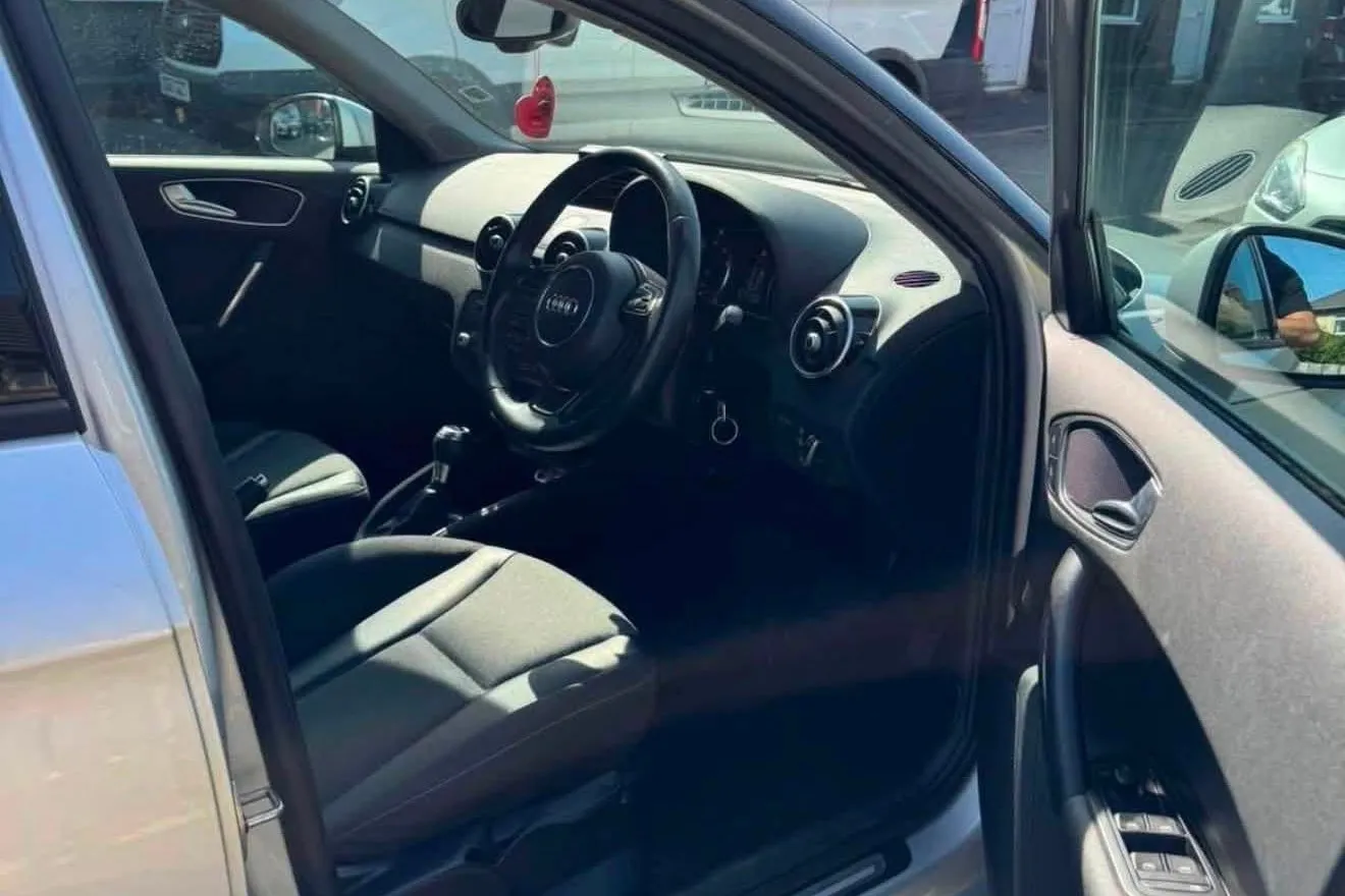 Audi A1 Sportback interior showing dashboard, steering wheel and driver's seat