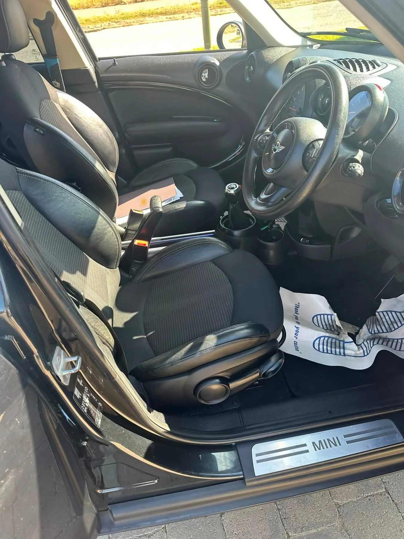 MINI Countryman interior showing the front seats, steering wheel and MINI door sill